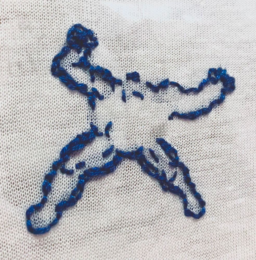 unfinished embroidery work in the shape of the body of Venom