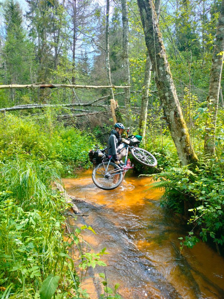 Me carrying my bike over a small river.