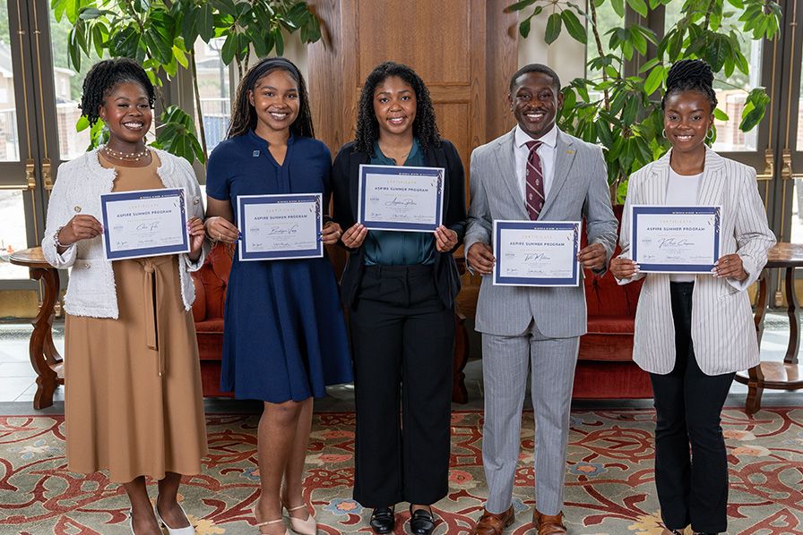 ASPIRE 2025 students posing as a group with their certificates for completing the summer 2025 ASPIRE program.