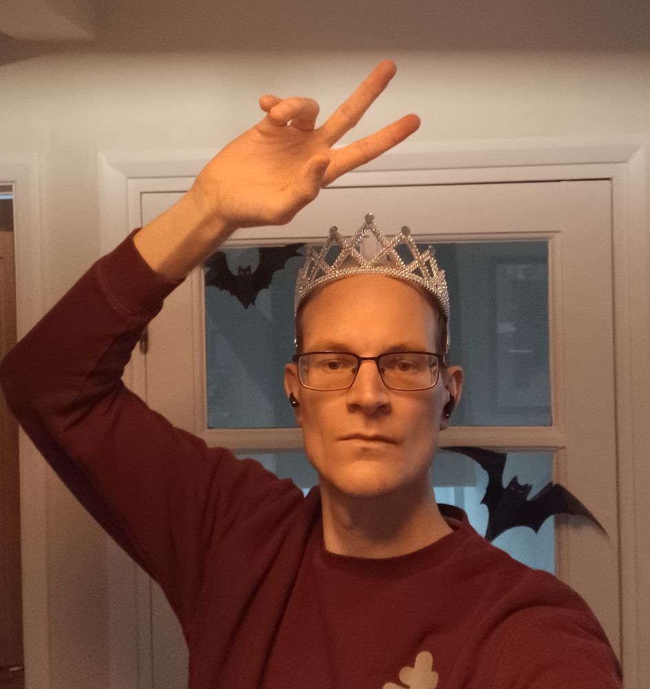 Drapps in a tiara in front of some bats