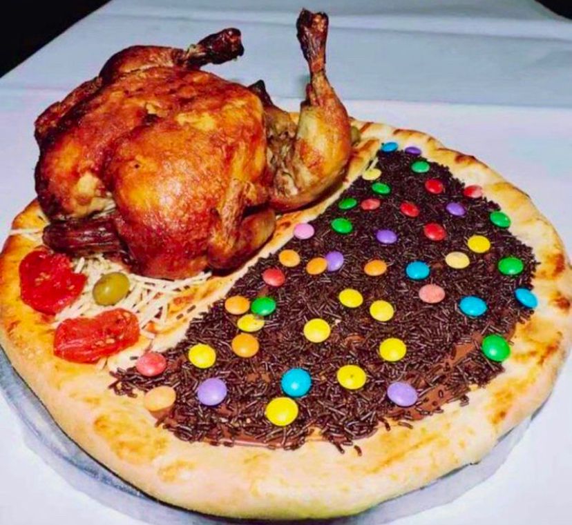 Pizza with whole chicken and pepperoni on one side and chocolate and M&Ms on the other side