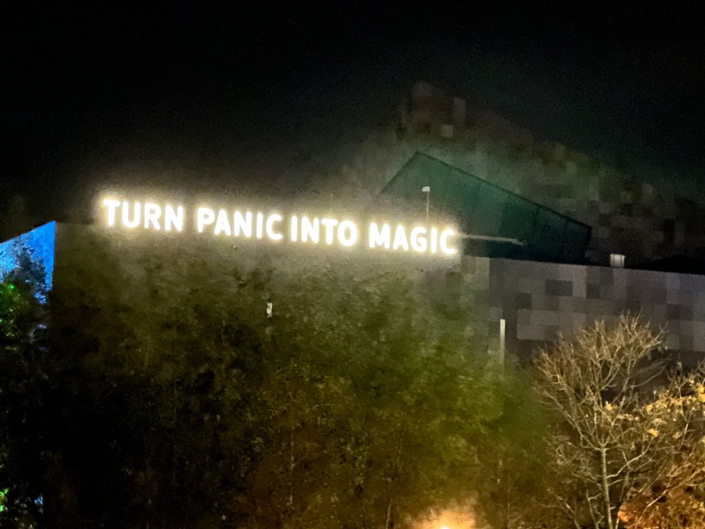 sign that says “turn panic into magic”