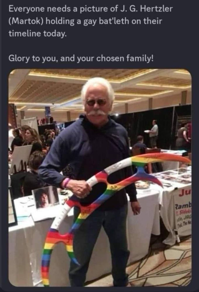 Caption reads: Everyone needs a photo of JG Hertzler (Martok) holding a gay bat’leth on their timeline today.

Glory to you, and your chosen family!