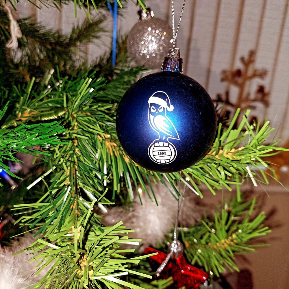Royal blue bauble with the Oldham Athletic crest and the owl wearing a Santa hat 