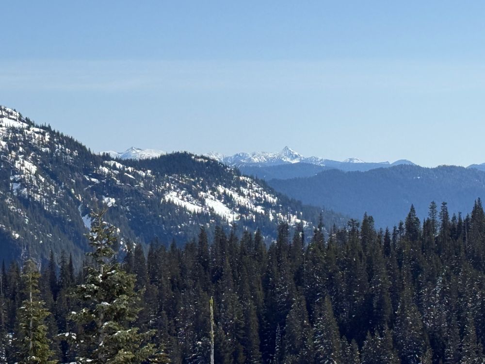 I think that is Mount Aix in the distance in the valley between on the flank of Rainier and further to the right is Bismark Peak (pointed peak).