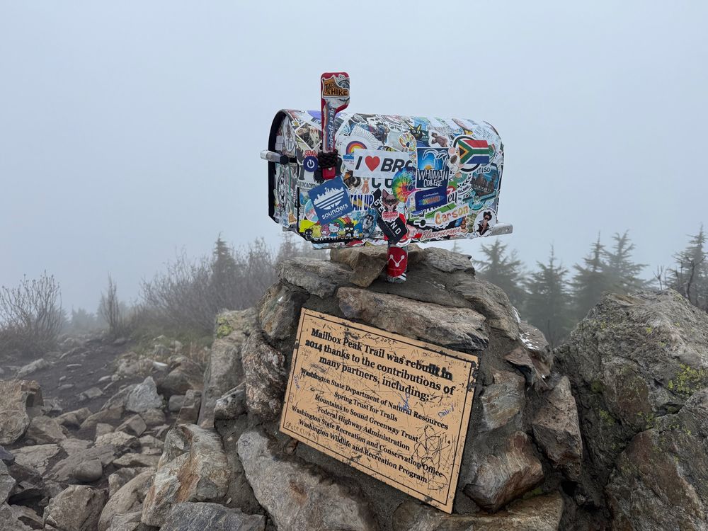Mailbox peak summit, photo of the mailbox and plaque at the top.