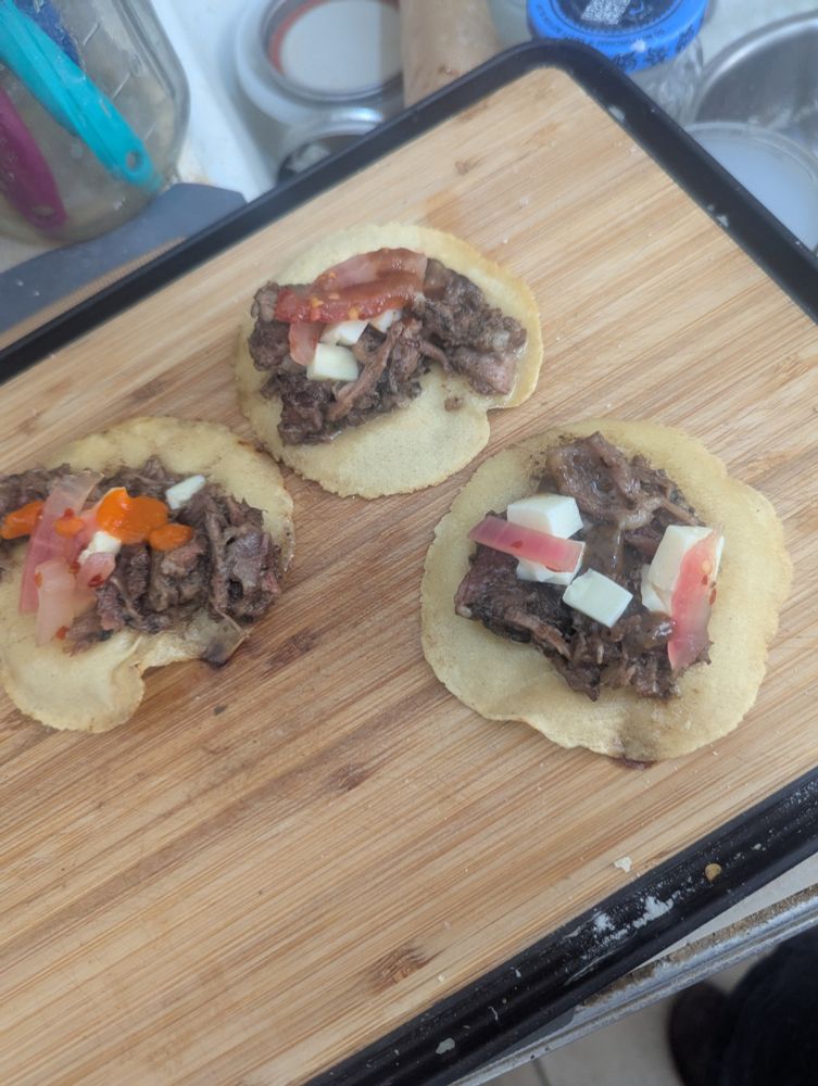 three small tacos on a cutting board