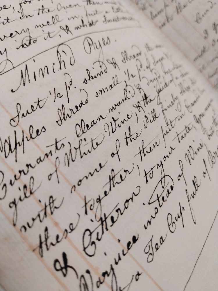 A close-up of a handwritten recipe in cursive script on a page, detailing ingredients and instructions for a dish.