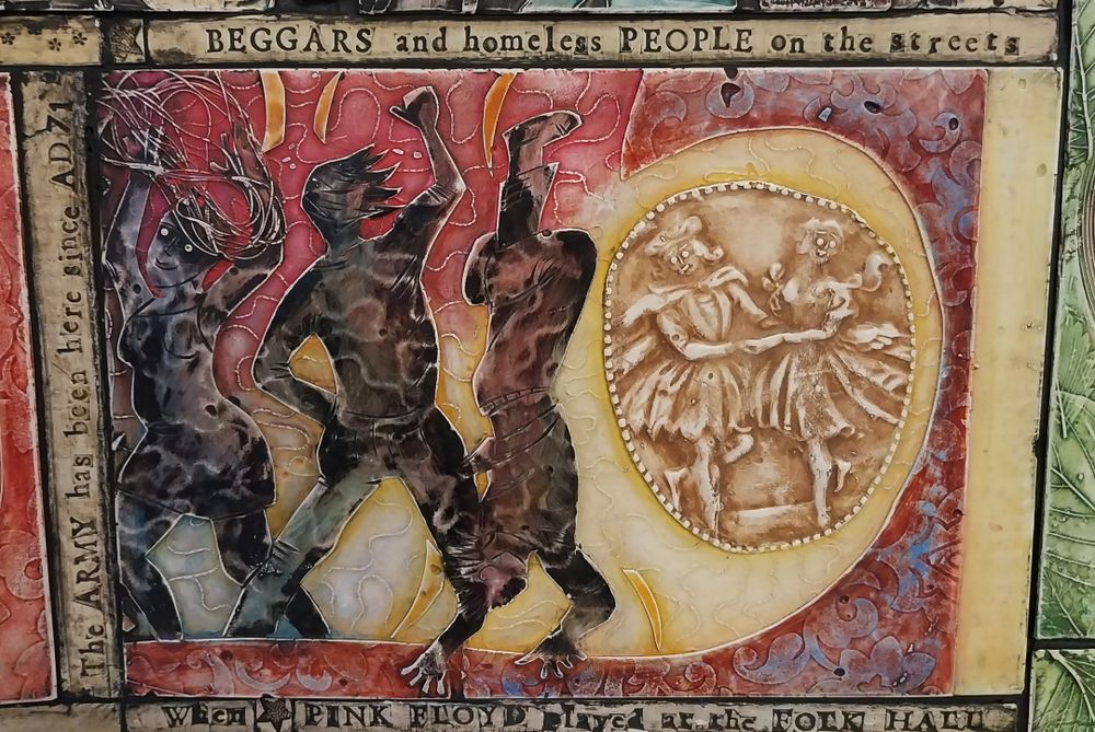 Three abstract figures dance energetically next to a vintage-style depiction of two people dancing. Text above reads, "Beggars and homeless people on the streets."