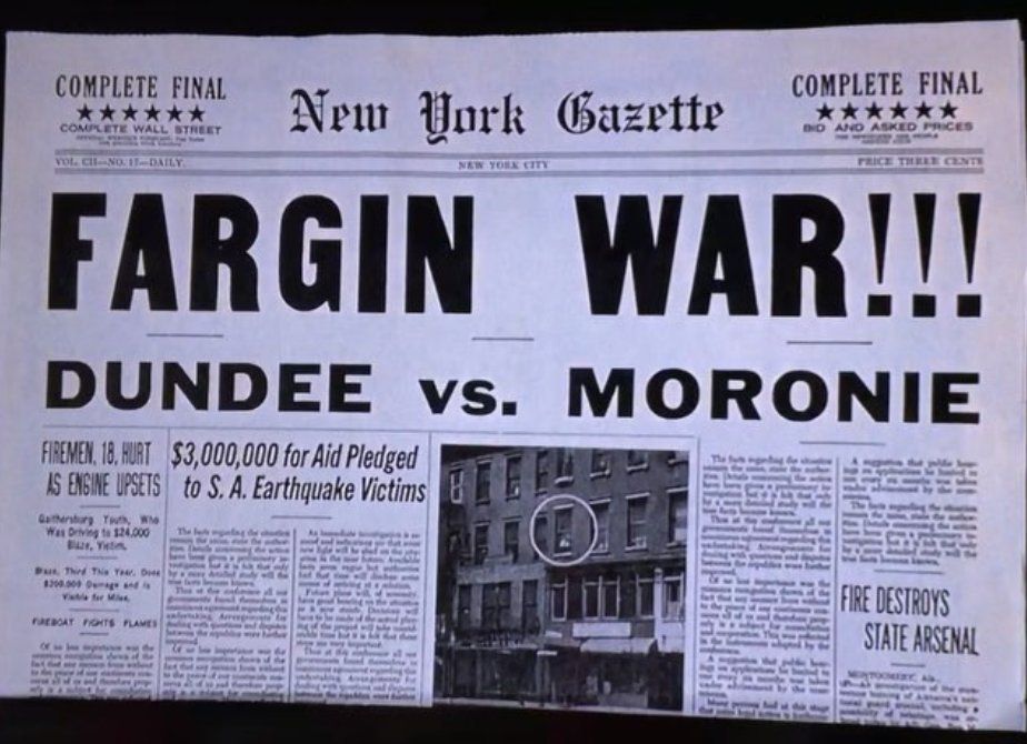 Still from "Johnny Dangerously" (1984) showing a "New York Gazette" front page with a bold headline that reads: FARGIN WAR !!!