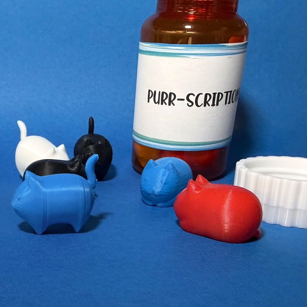 3D printed cats from a prescription bottle titled "Purr-Scriptions"
