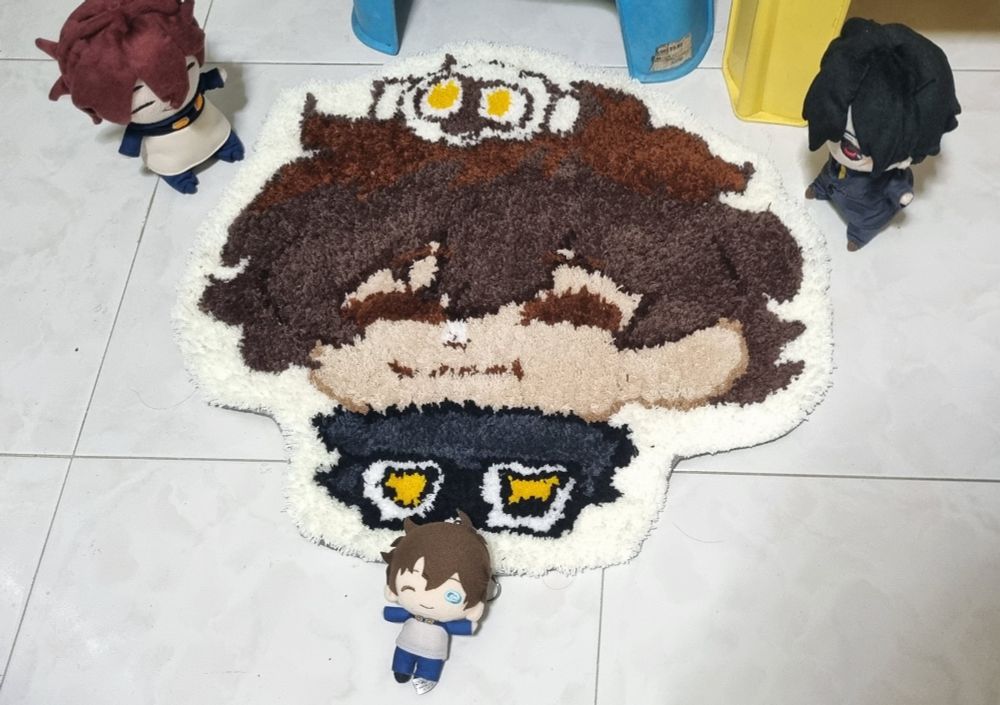 The fully completed rug on the floor. With plush leo, Steven and smaller leo posing around the rug in an upside down triangle formation