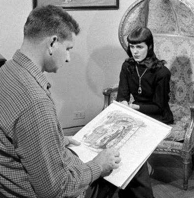 Charles Addams drawing an Addams Family cartoon using his wife Barbara Jean as a model 