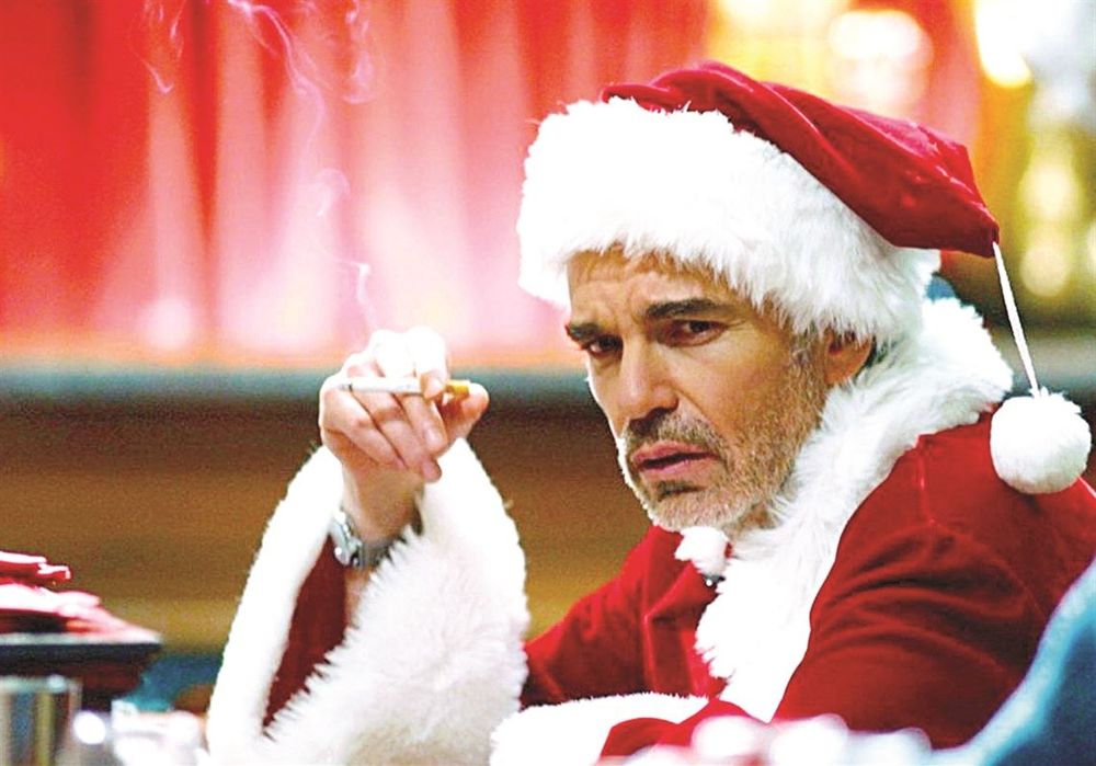 grizzled Billy Bob Thornton from 'Bad Santa' sitting at a bar in his Santa costume smoking a cigarette looking unhappy 