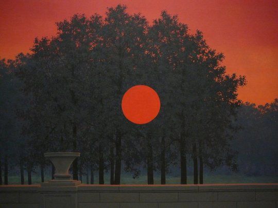 red skied vista of trees and a garden wall with a perfect red circle in the center of the painting