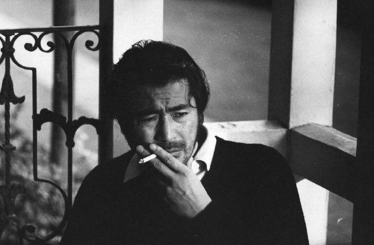 Toshiro Mifune smoking a cig and looking morose 