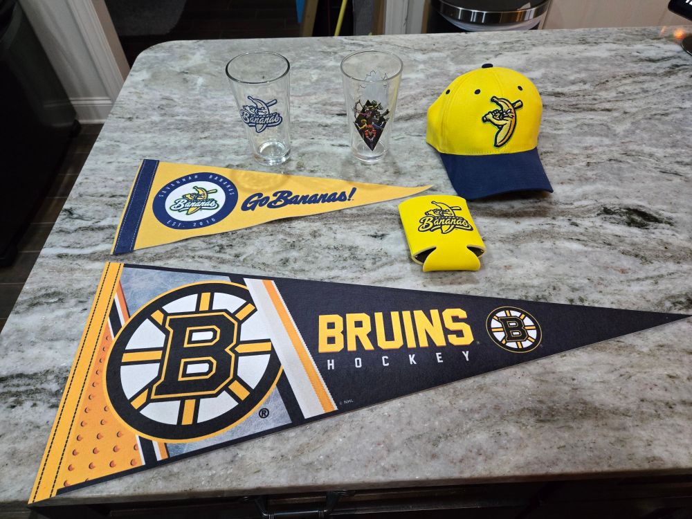 Two Pennants, one coozie, two pint glasses, and one hat.