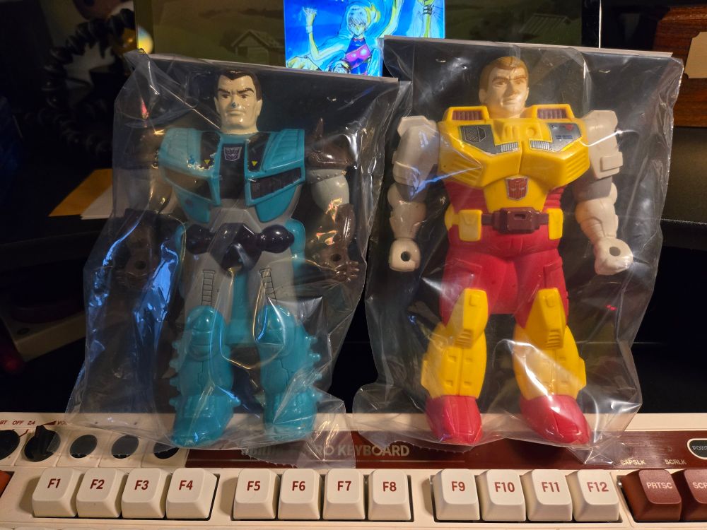 Two Pretender Transformers shells.  Humanoid, one blue and one yellow.