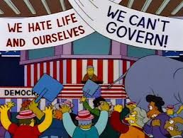 political convention in the style of the Simpsons. Banners say "We hate life and ourselves" and "we can't govern!"