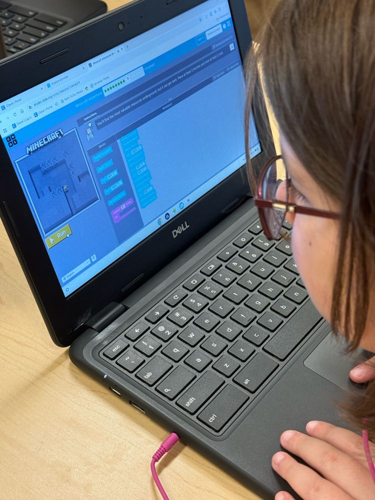 Child coding a Minecraft game on hourofcode
