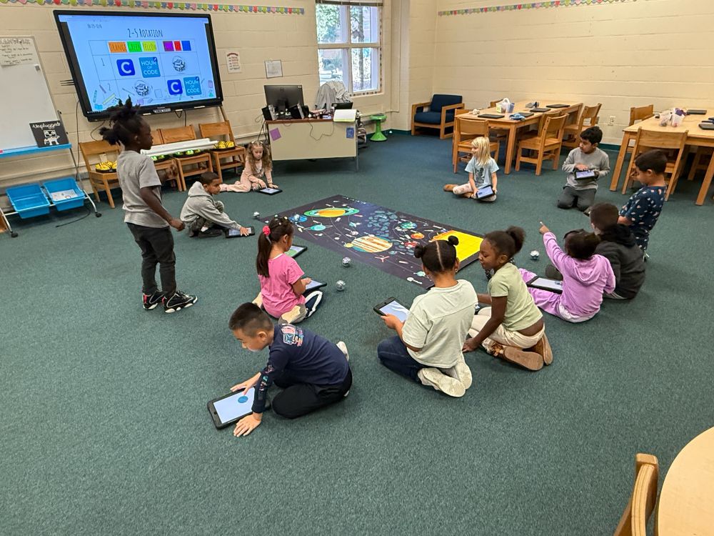 Children playing with sphero robots