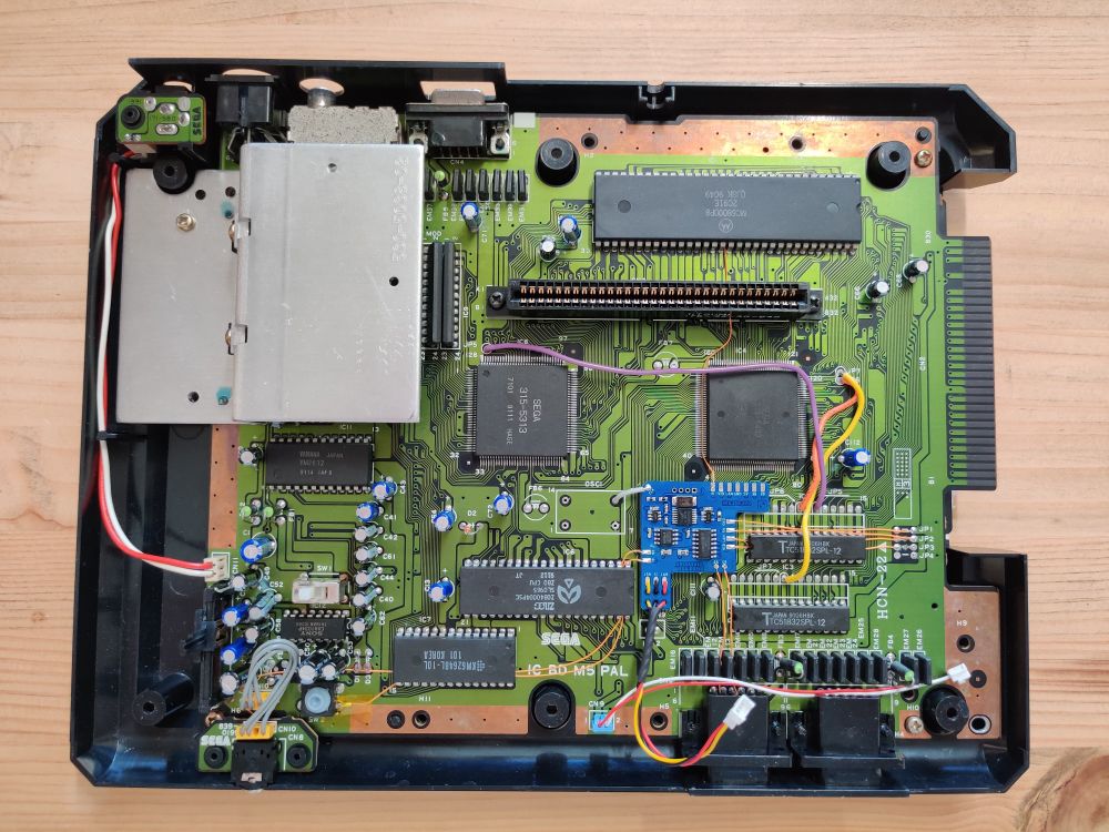 Sega Mega Drive (Asia PAL) top shell removed with a region mod installed.