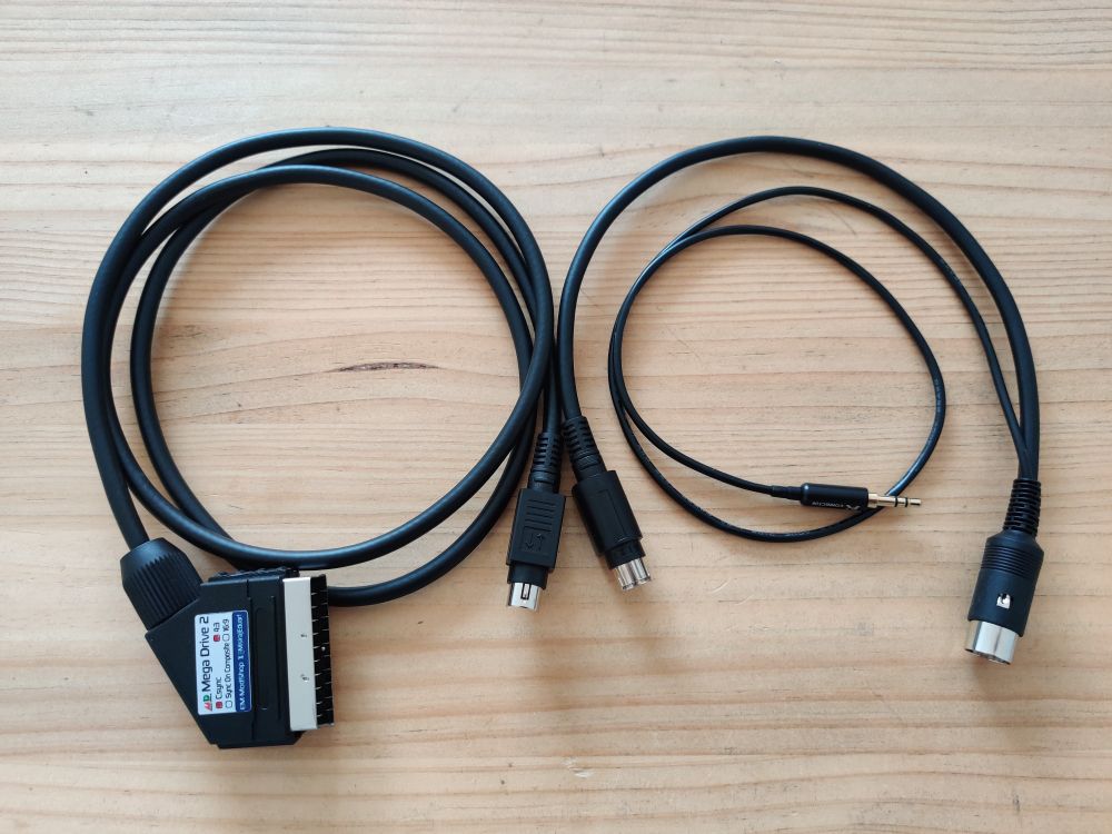 Custom cables for Sega Mega Drive and 32X on a wooden table.