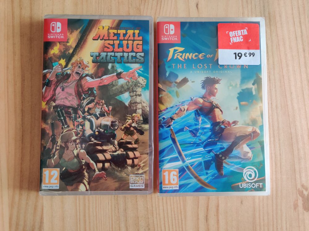 Metal Slug Tactics and Prince of Persia the Lost Crown for the Switch on a wooden table. PoP has a red and white label with "OFERTA FNAC 19€99"