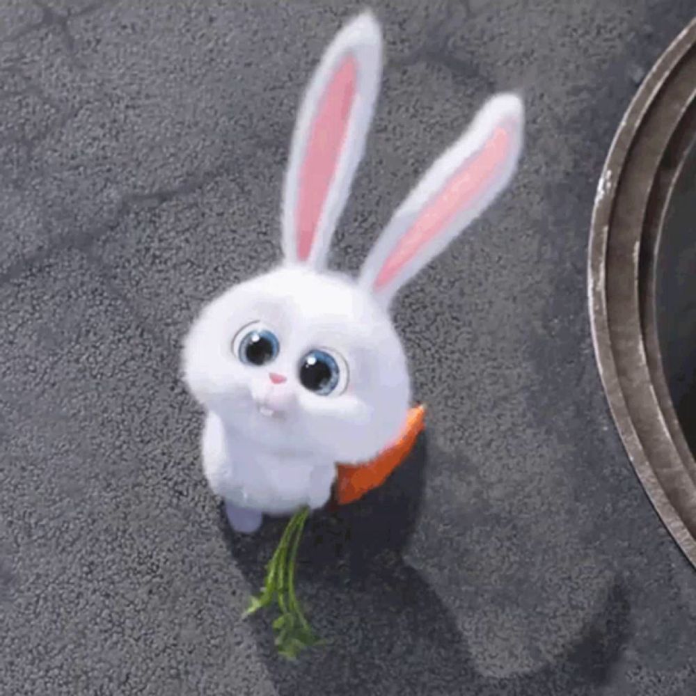 a white bunny rabbit holding a carrot in its mouth