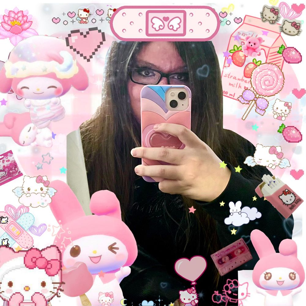 A mirror selfie, this time with a bunch of kawaii and My Melody stickers. A Hello Kitty sticker and heart stickers, along with a strawberry milk sticker. The background is light pink.