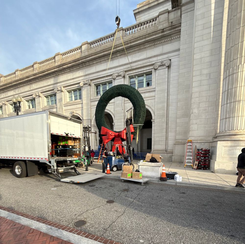 A wreath being pulled up to be placed in its place of honor 
