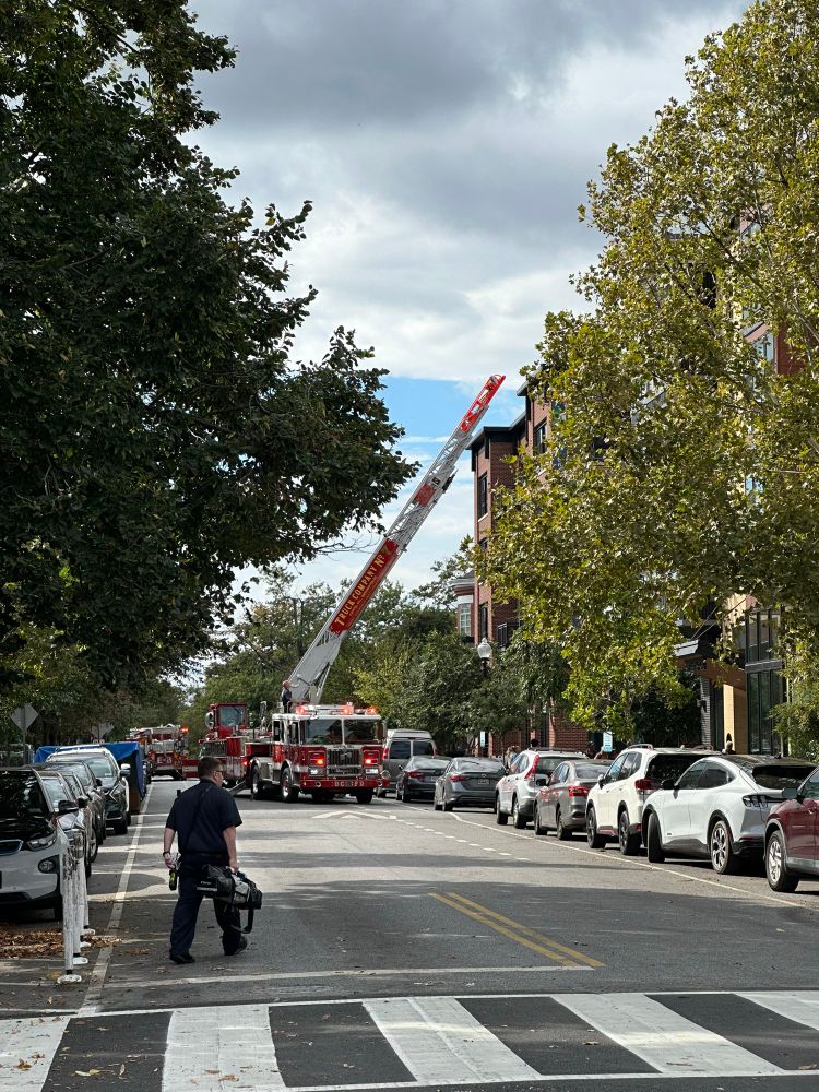 A ladder truck ladder hovers in the background at the 1300 block of E Street SE. Reader photo. 