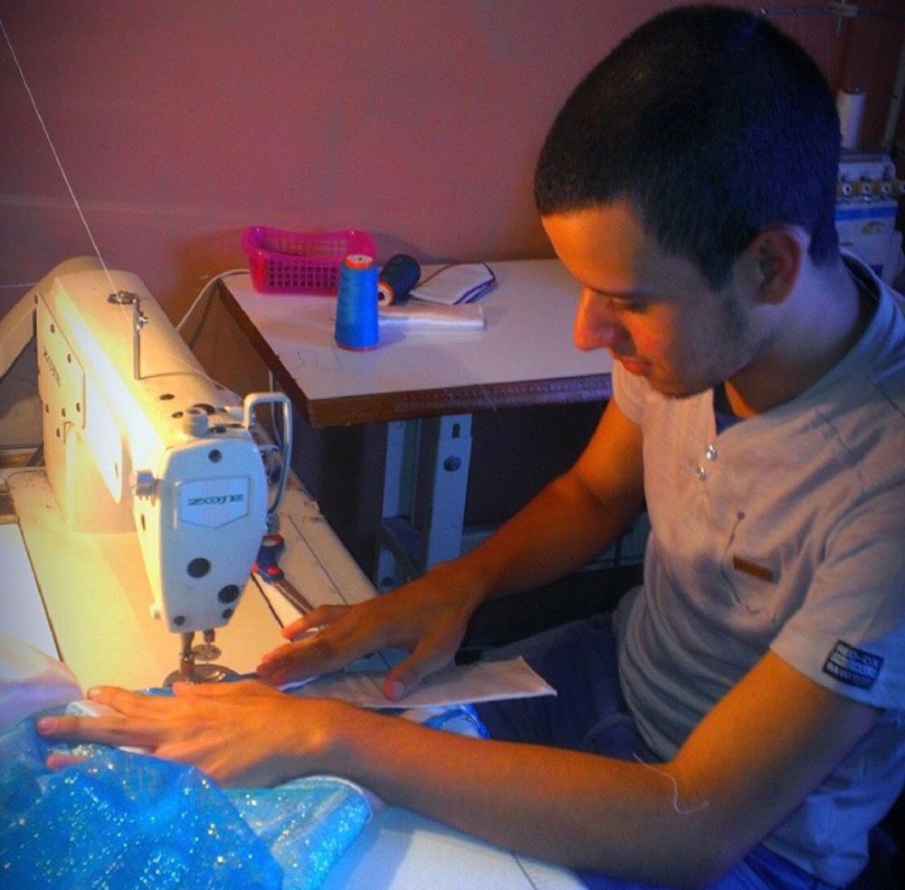 Andry José Hernández Romero, as a teen, sewing costumes for his town’s Three Kings Fest. 