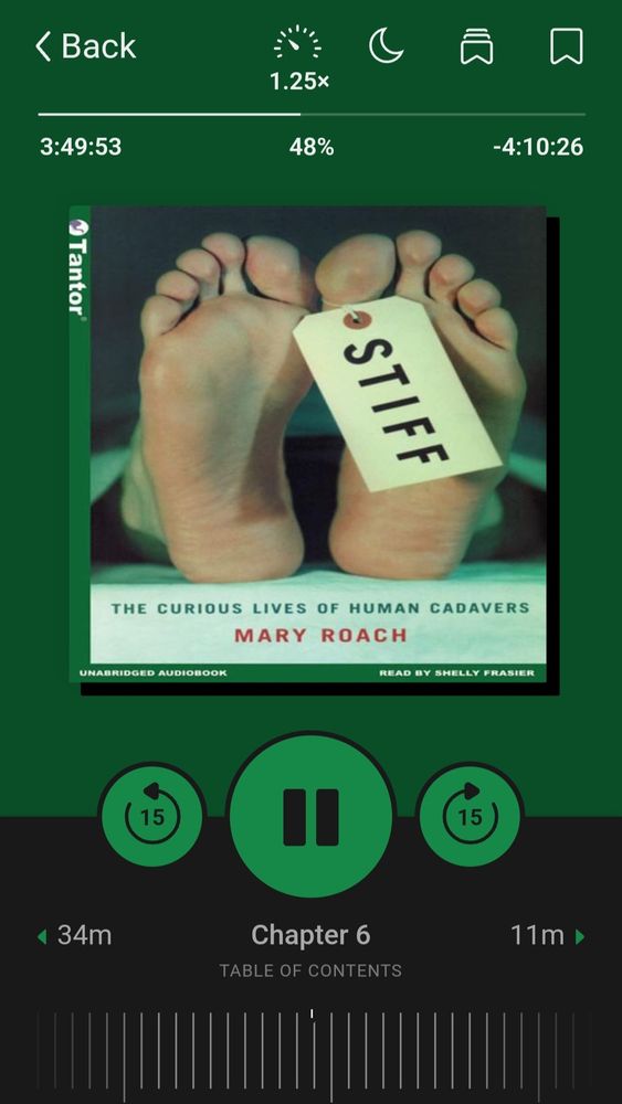 Green audiobook cover. Stiff: the Curious Lives of Human Cadavers by Mary Roach. Image of human bare feet, with a toe tag. Name of the book, STIFF, on tag. 