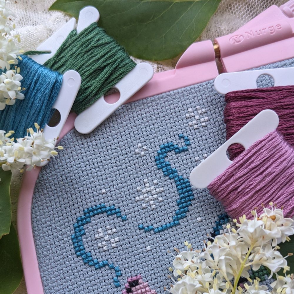 Sneak peek of a cross stitch pattern releasing soon. Features blue steam swirls and snowflakes coming out of a sprout.