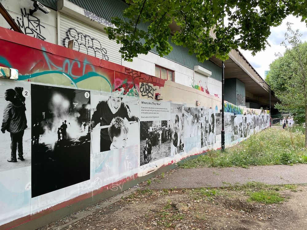 Wall of photos of children playing in the streets of North Kensington in the 1960s
