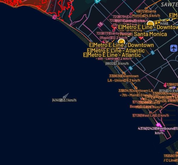 Zoomed in photo of Metro Bus 4145 in the Pacific Ocean, southwest of Santa Monica, with Metro E line and other buses currently operating.