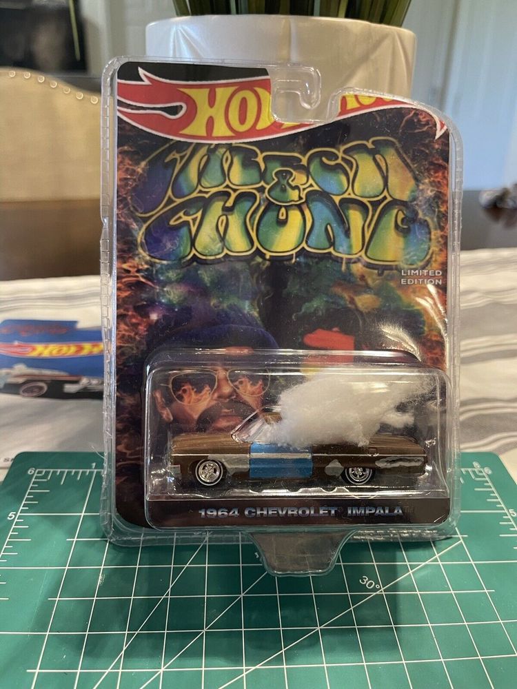 1964 chevy impala hot wheels toy in plastic retail clamshell with custom made hotwheels - cheech and chong display card. Impala is painted and custom crafted to look like Cheech and Chong's car from "Up in smoke", complete with cottonball 'smoke' drifting out the driver's side window.