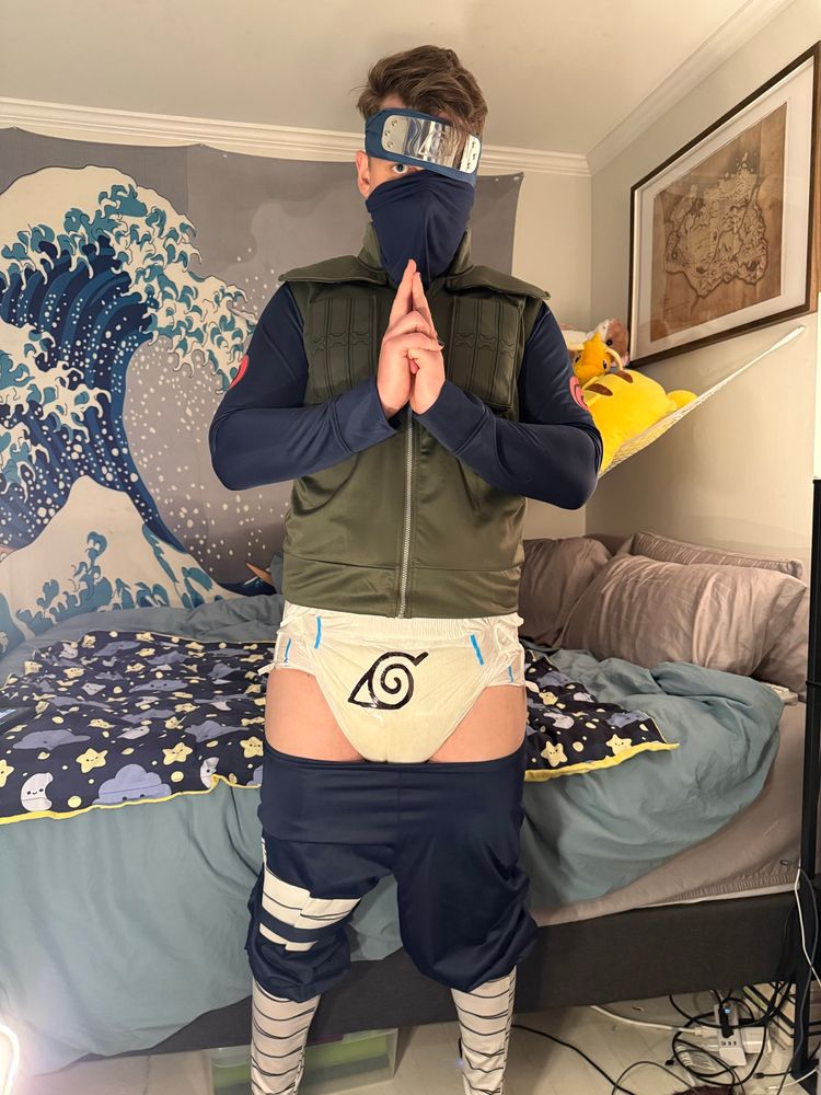 The shinobi is doing another hand sign, but this time his pants have slightly fallen down and… is that a diaper with the konaha symbol on it?!