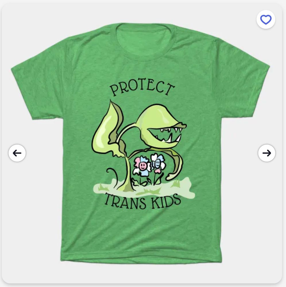 A green Tshirt with a cartoony carnivorous plant protecting two young flowers in pink / blue / white trans flag colors. Text reads "Protect Trans Kids"