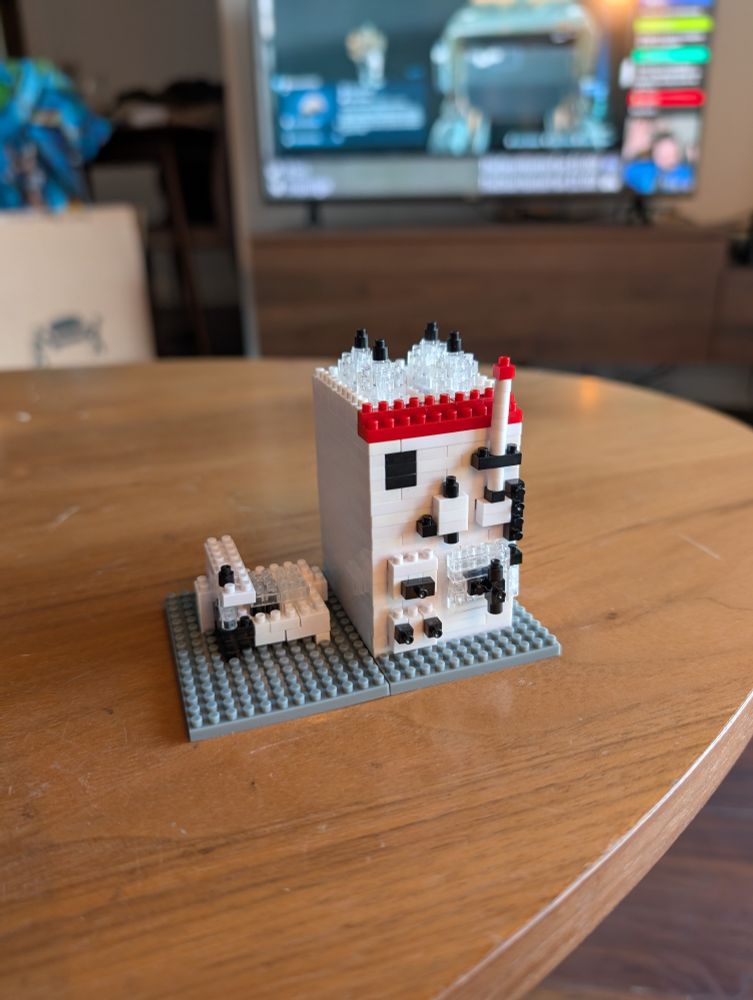 A Lego model of an AKTA FPLC system sits on a coffee table.