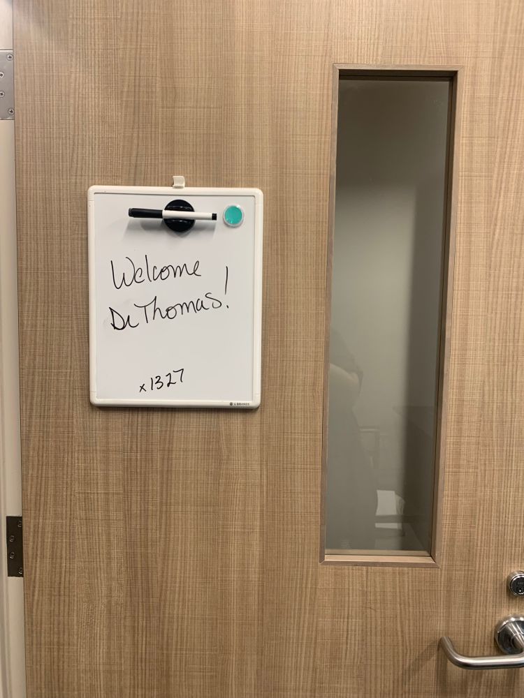 An office door with a white board on it that reads “Welcome Dr. Thomas!”