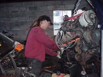 Me standing in a Chevy Caprice engine bay helping a friend replace his engine