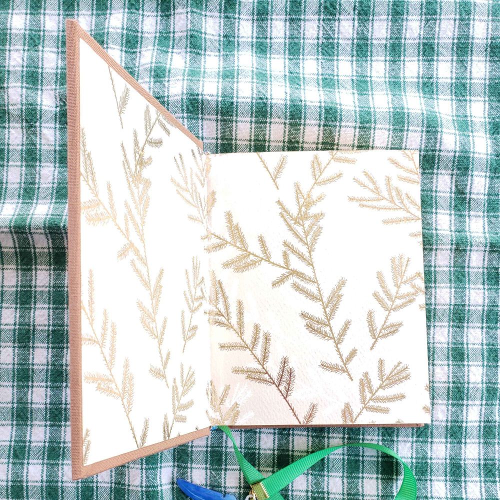 The endpages of the book. The design is of firs in gold.