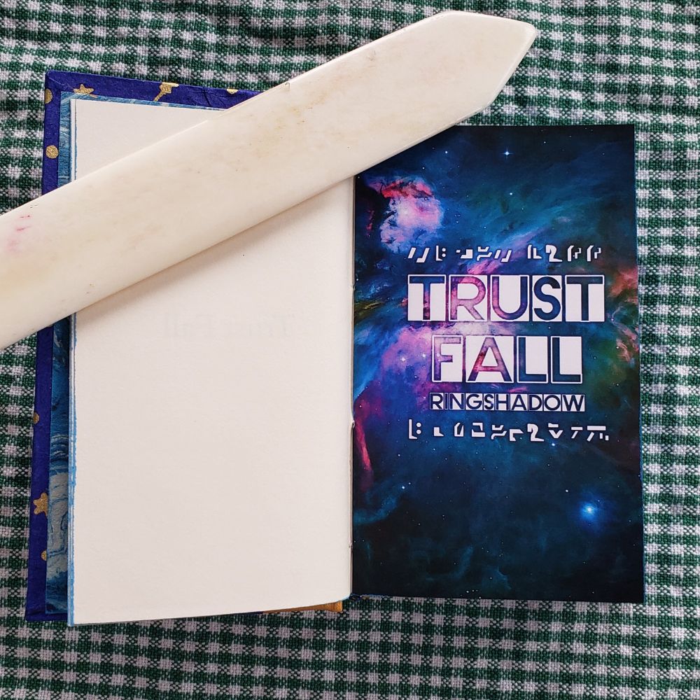 The title page. The title "Trust Fall" and the name of the author "Ringshadow" are in white text on top of an edited picture of the Orion Nebula. 