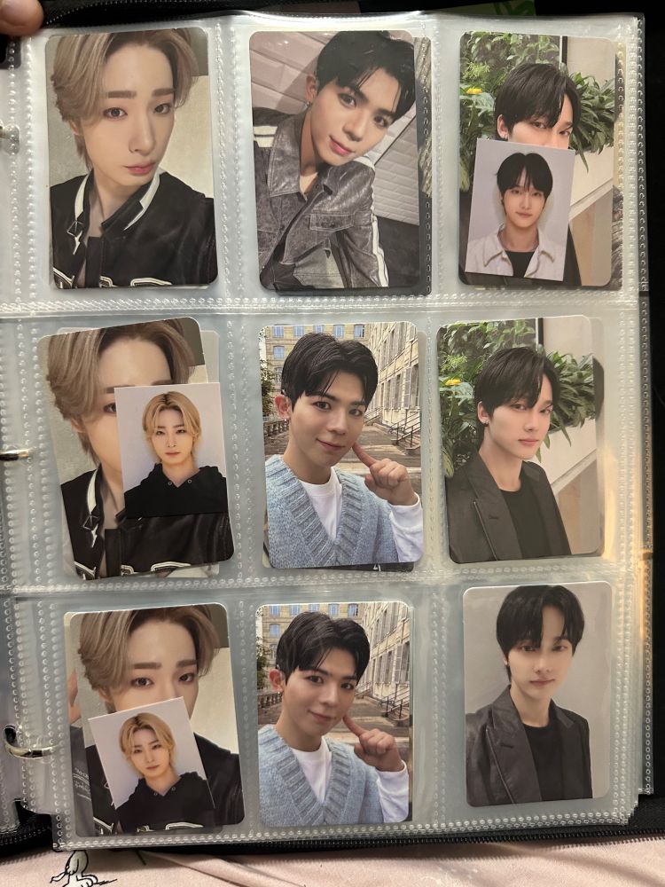 Pc binder opened yo a page with BigOcean Cards 
Left to right Column 
Left- all three are of Jiseok in a black jacket, bottom two have a mini photo of Jiseok in a black hoodie.
Middle- top photo of Chanyeon in a Jean jacket with a white stripe down the arm and the bottom two are Chanyeon in a white long sleeve with a blue sweater vest touching his cheek.
Right-top two photos of Hyunjin in a black shirt and black jacket in front of a tree and bottom photo is of Hyunjin with a black shirt and black jacket in front of a white wall. The top photo has a mini photo of Hyunjin in a black tee and white button up slipped in front of the main photo. 