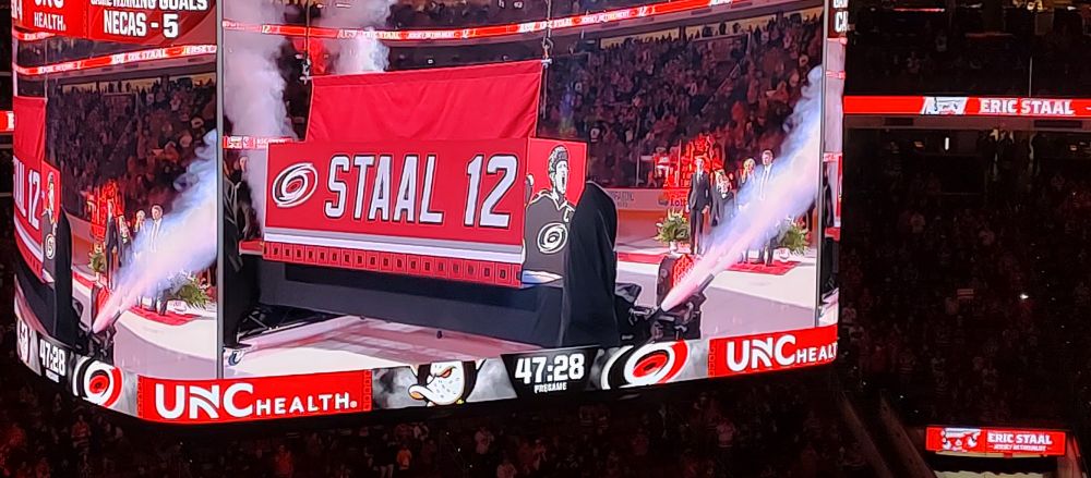 Jumbotron view of Eric Staal's jersey lifting up to the rafters.
