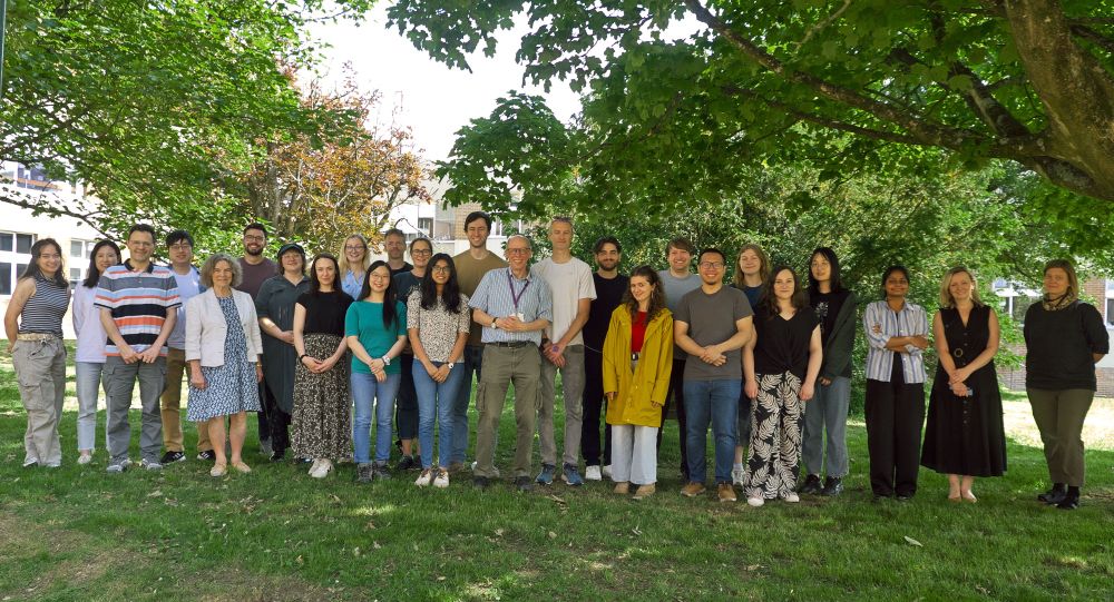 Everyone from the joint meeting stood together under some trees.