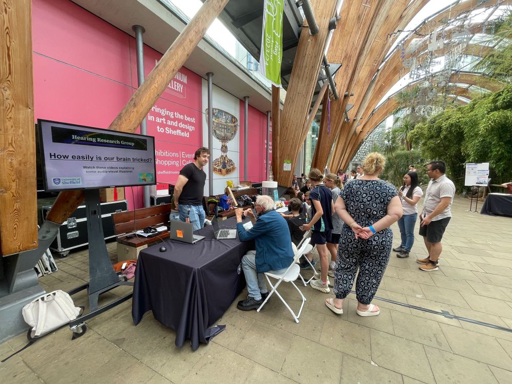 people gathered around the tables of activities.