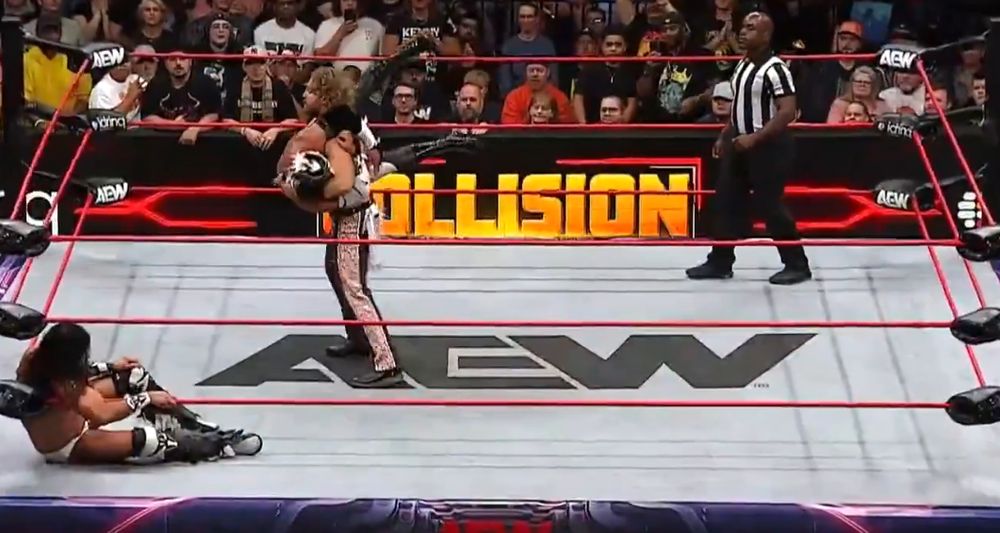 Hangman Adam Page during an AEW match with a tiny black cartoon cowboy hat photoshopped onto his head.